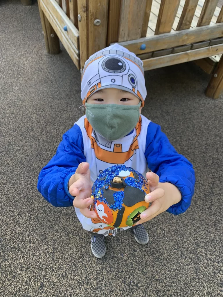 Preschooler holding a ball