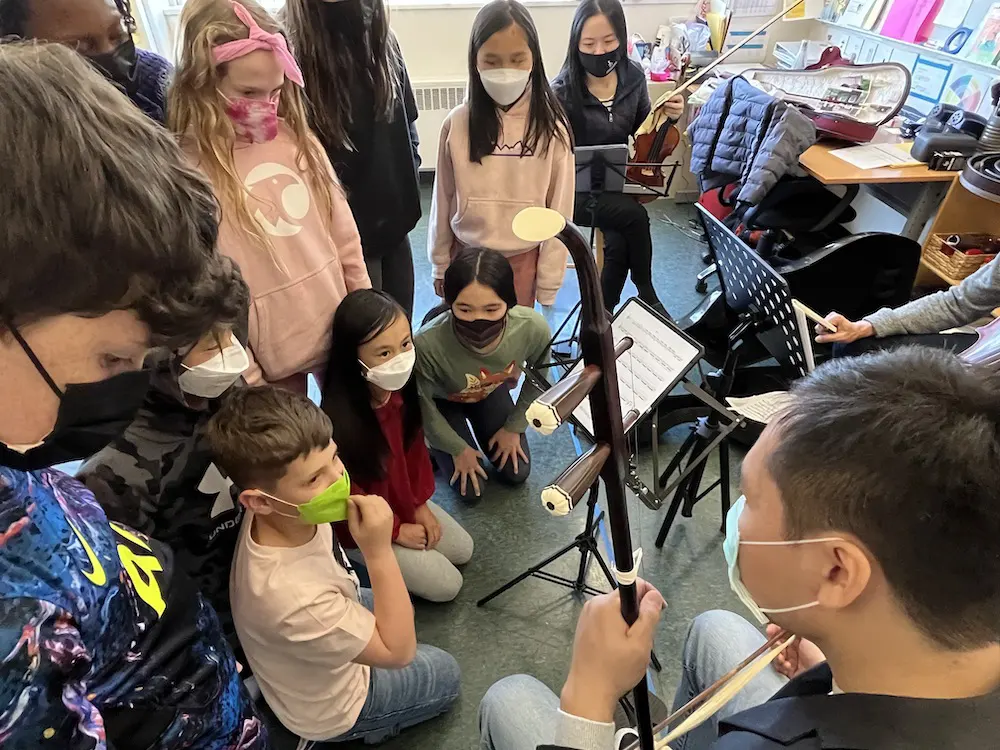 Andy Lin demonstrates the erhu for CAIS students