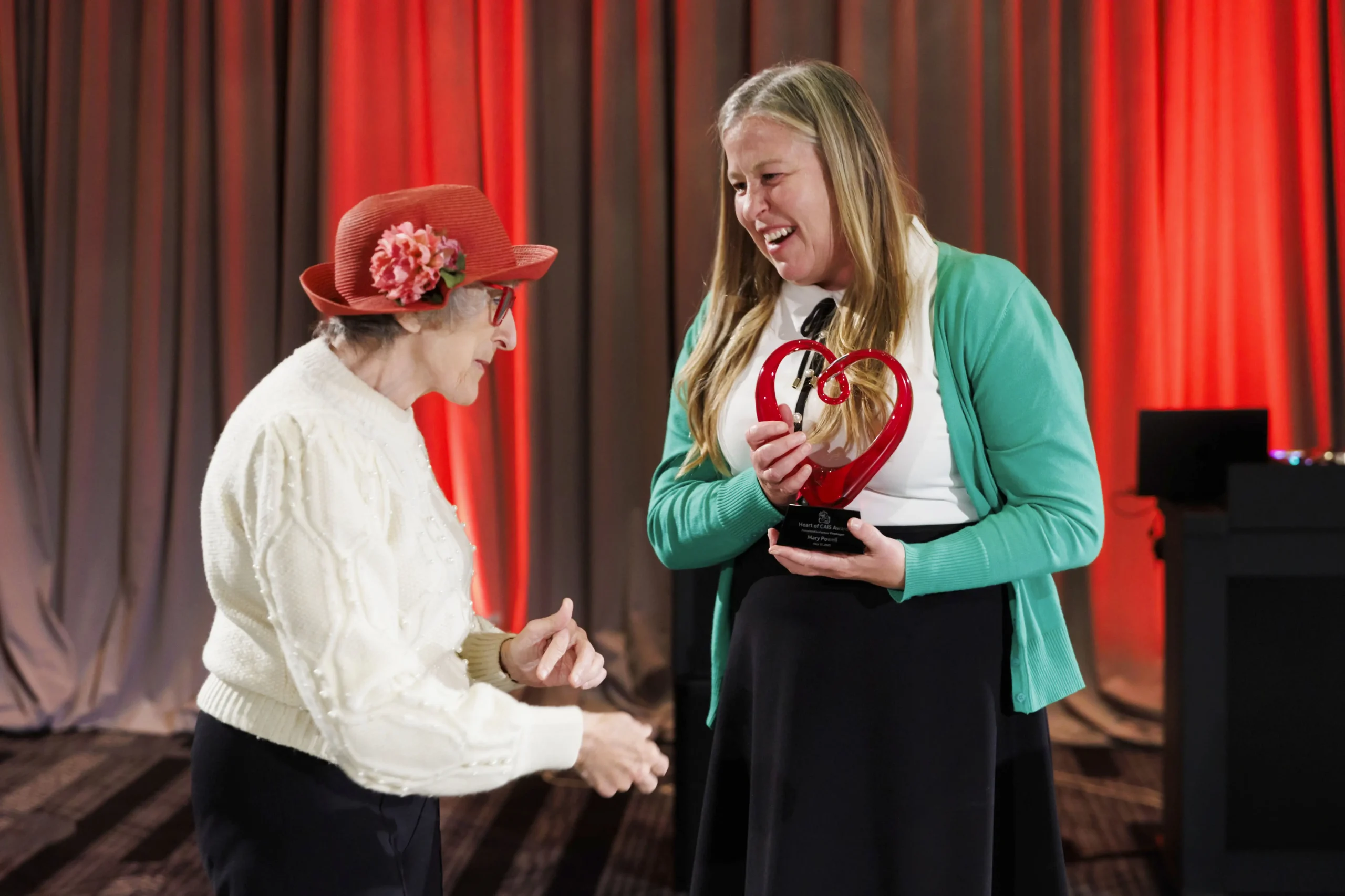 CAIS Founder Carol Ruth Silver presents Heart of CAIS Award to former Board Chair Mary Powell